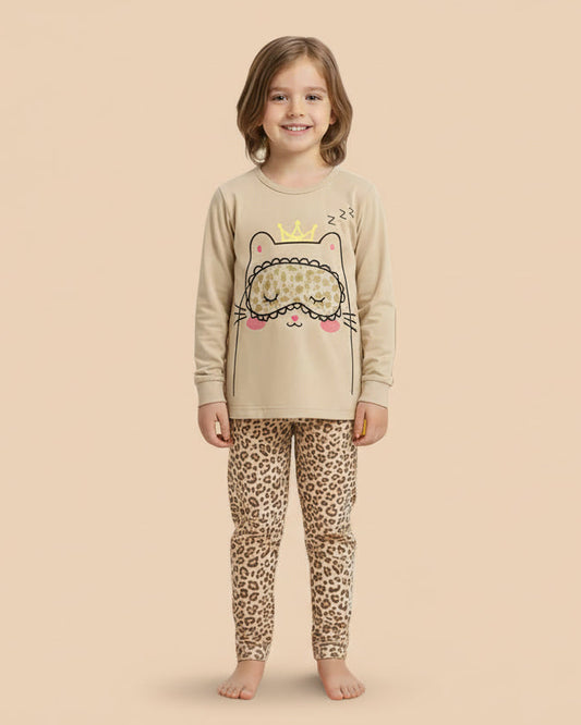 Child wearing a beige long-sleeve top with a cat design and leopard print pants on a white background